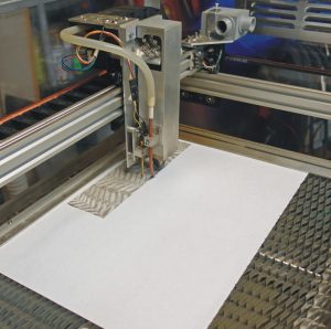 Laser in process of engraving/cutting paper